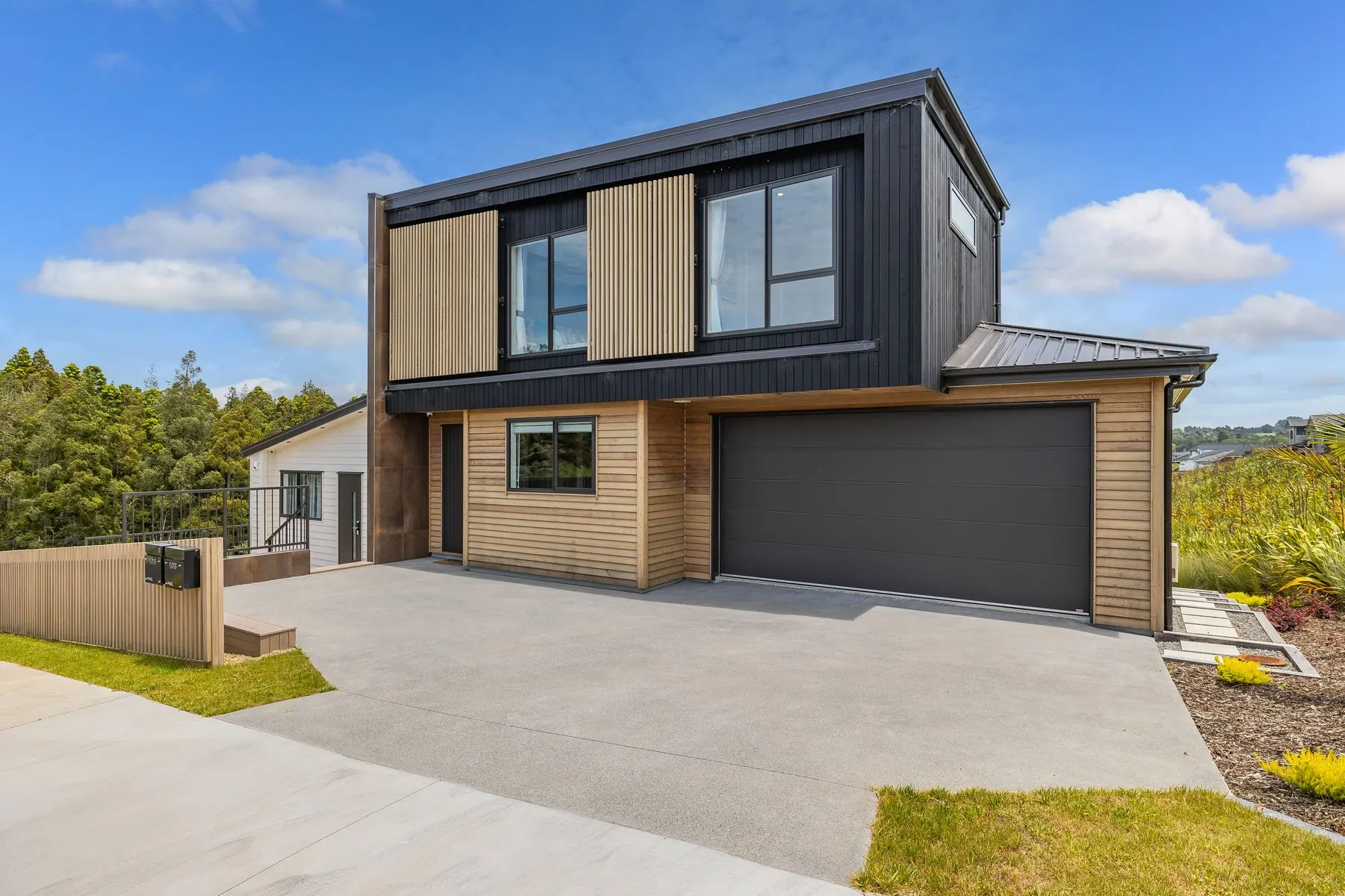 Concord Homes show home exterior in Milldale - timber and dark cladding with double garage